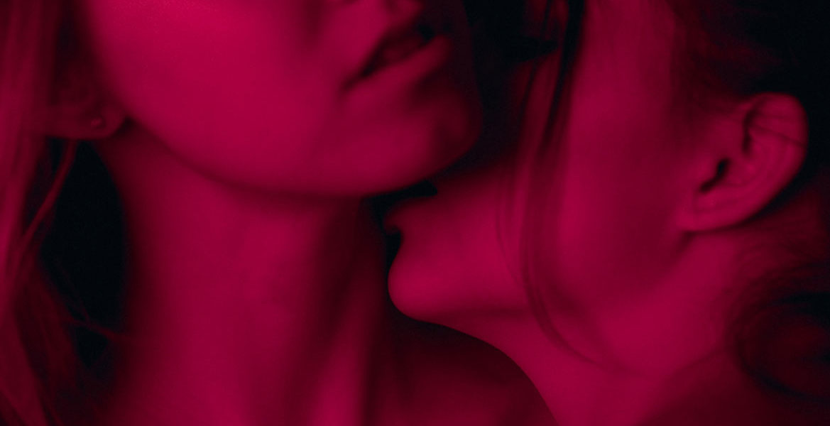 woman kissing another womans neck