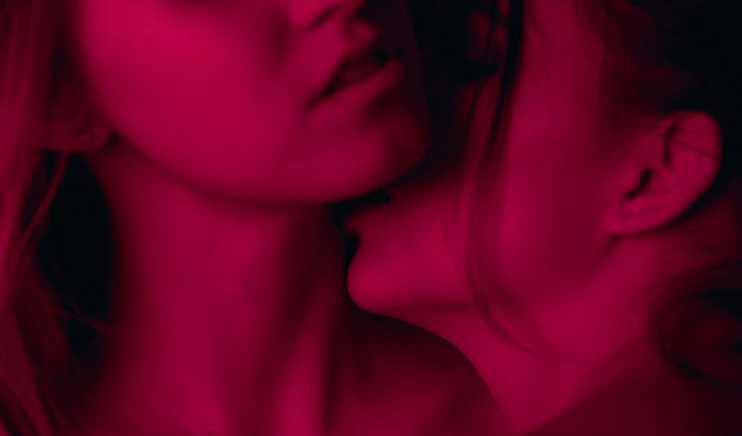 woman kissing another womans neck