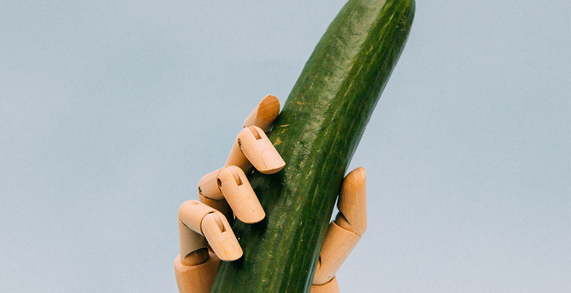 Robot hand holding a cucumber