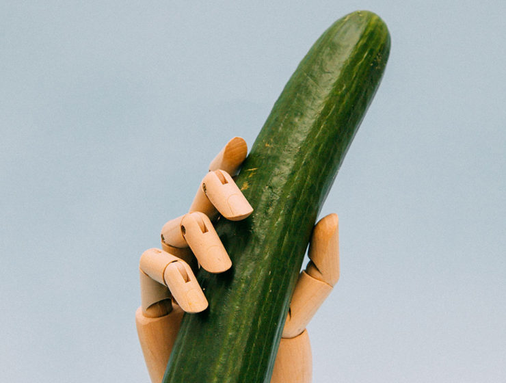 Robot hand holding a cucumber