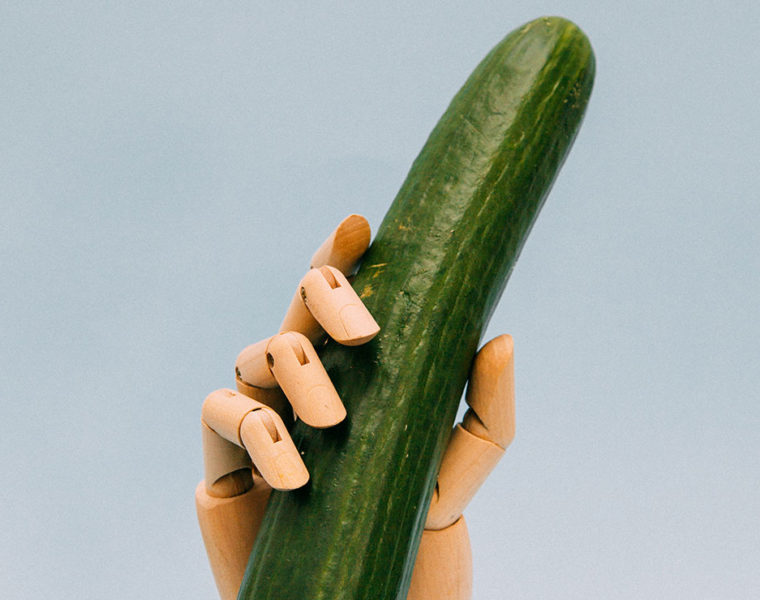 Robot hand holding a cucumber