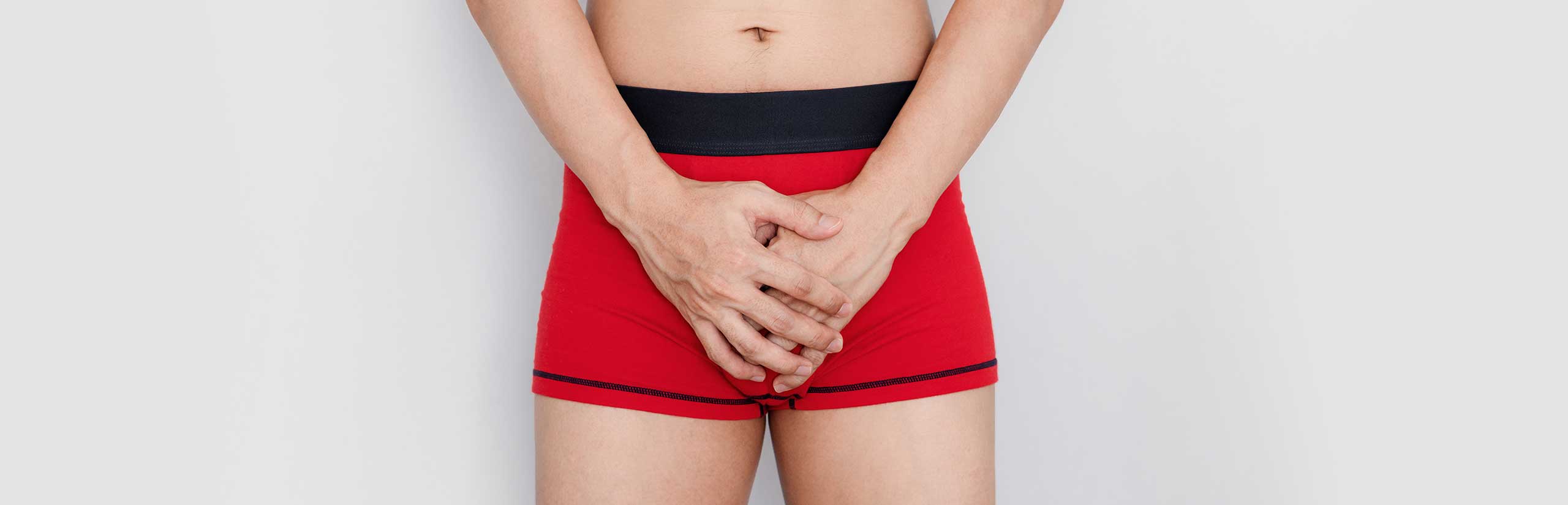 Man covering his crotch with his hands