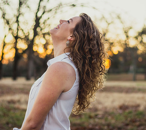 A woman outdoors at sunset