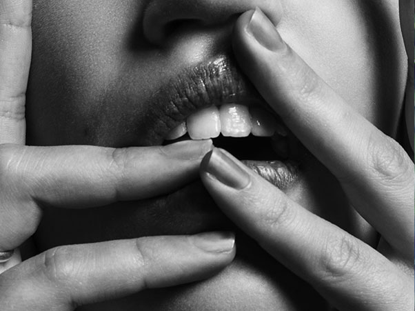 Woman touching her mouth with her hands