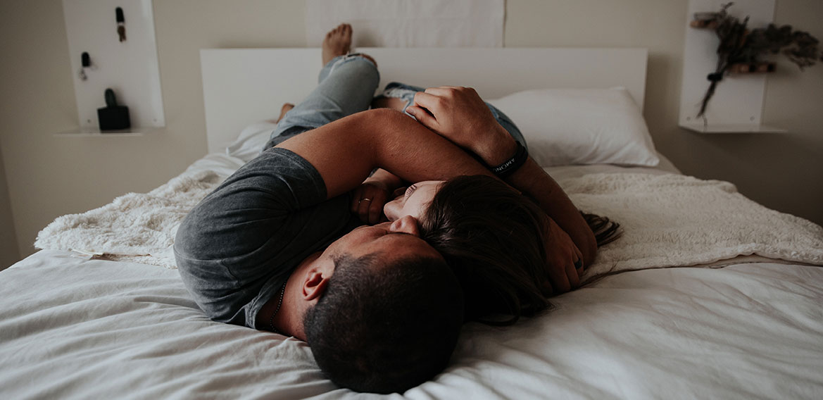 A couple embracing in bed