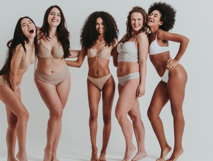 A group of happy women in their underwear.