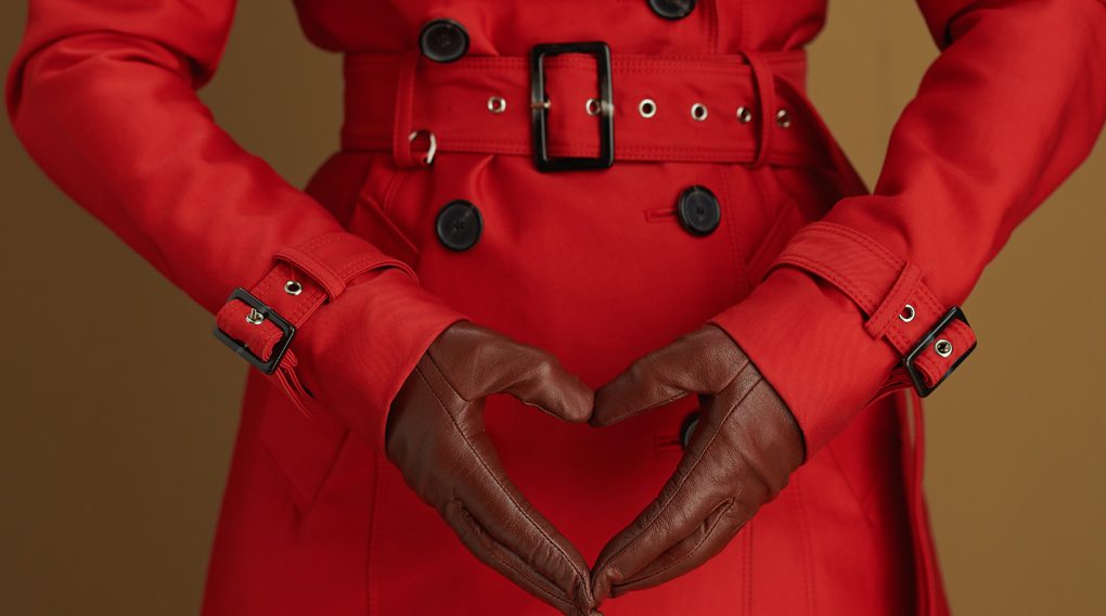 Woman in a red coat with black gloves