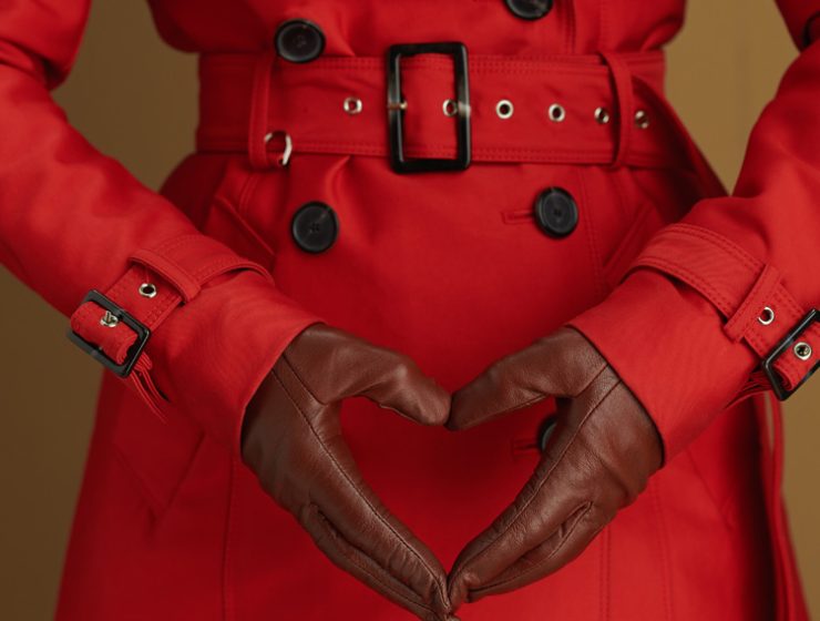 Woman in a red coat with black gloves