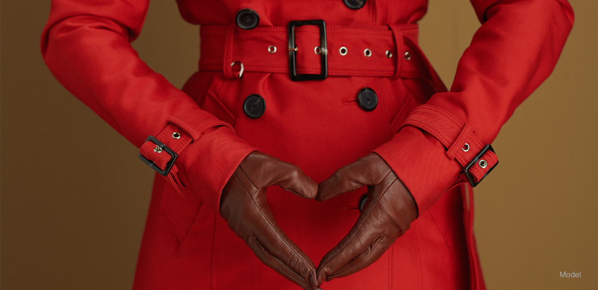 Woman in a red coat with black gloves