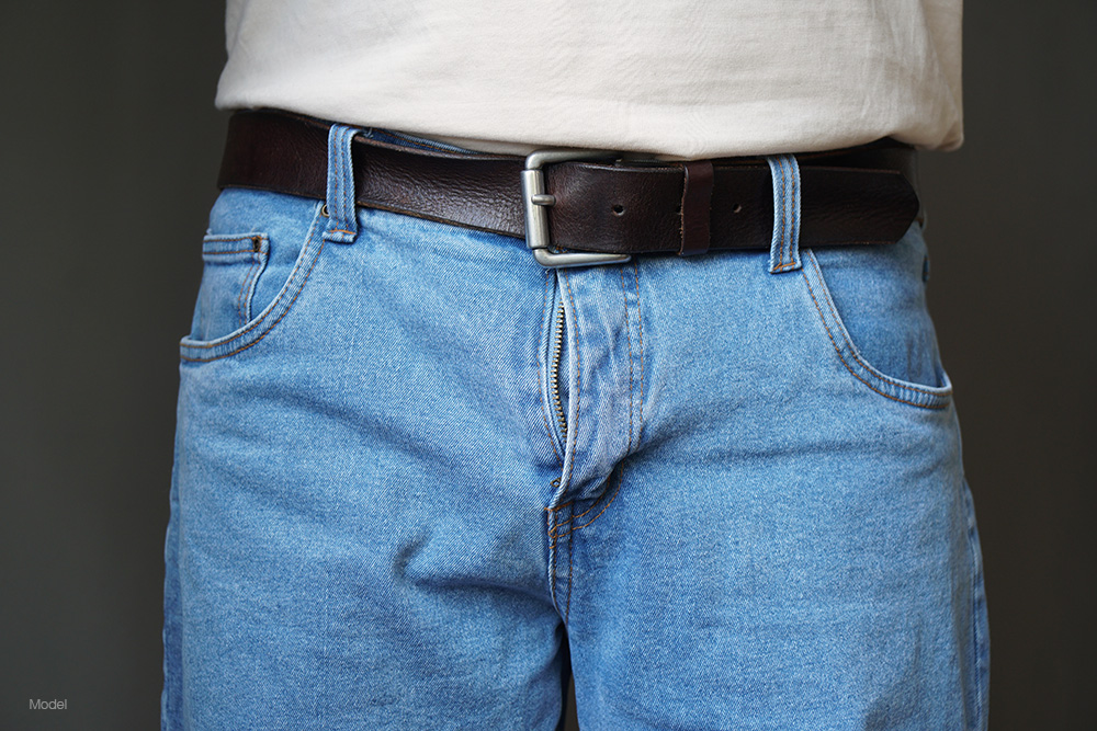 Lower half of a man in jeans
